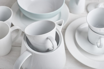 white dishes on a wooden white background