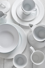 white dishes on a wooden white background