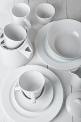 white dishes on a wooden white background