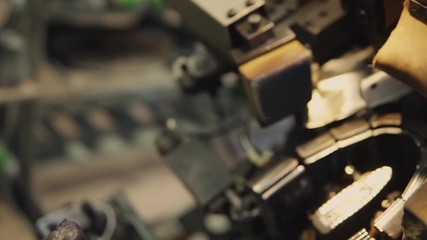 Man use special machine tool for making a shoes. The conveyor on a shoes factory with shoe and sole. Mass production of footwear.