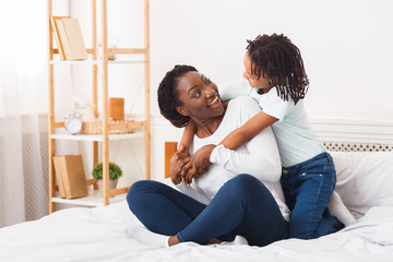 African american family cuddling in the bed