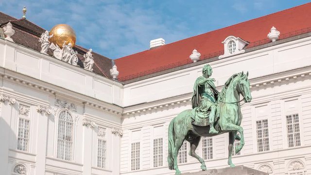 Equestrian statue of Holy Roman Emperor Joseph II riding a horse in Josefsplatz Square timelapse, Hofburg Palace in Vienna, Austria. Austrian National Library on a background