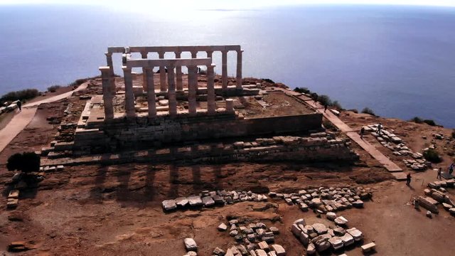 Greek Temple of Poseidon in Athens during day, descending aerial rotating right