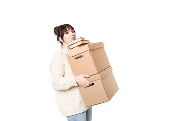 Brunette woman holding two heavy cardboards with books on top of them. Moving concept.