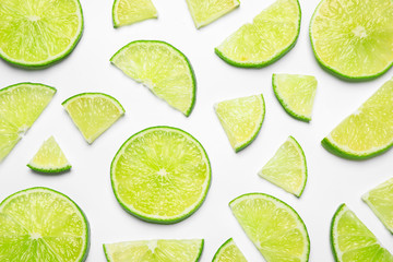 Juicy fresh lime slices on white background, top view