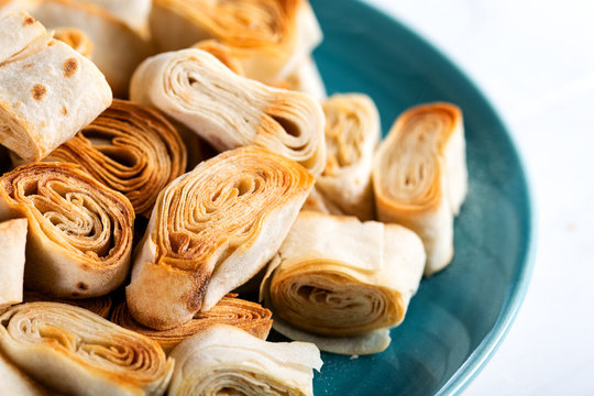 Turkish Food From Artvin called Silor / Rolled and Fried phyllo. Silor on blue plate.