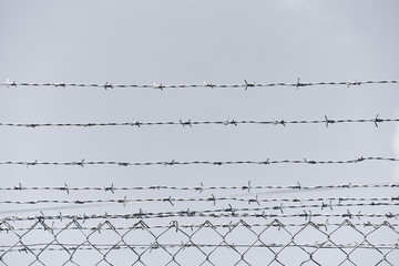 Iron barbed wire fence.Barbwire in security forbidden to entry,prison,military or private area.