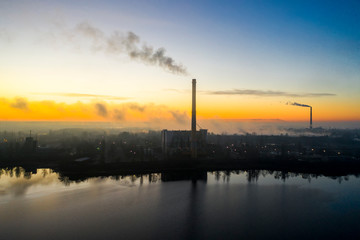 Fototapeta na wymiar Garbage incineration plant smokestack at sunrise. Environmental pollution.