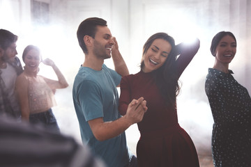 Lovely young couple dancing together at party