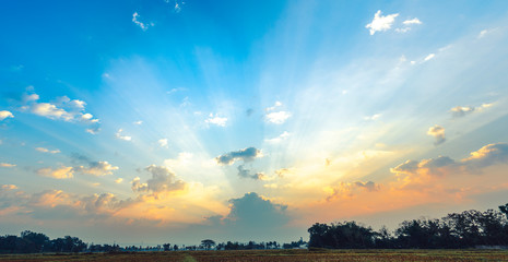 Obraz na płótnie Canvas Panorama sunbeam, Sunlight Sacred Shining through the clouds Creating a beautiful beam Is a mystery that must be searched. over the tree in the rice fields, Northern Thailand