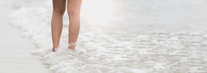 Woman foot walking on the beach, travel vacation.