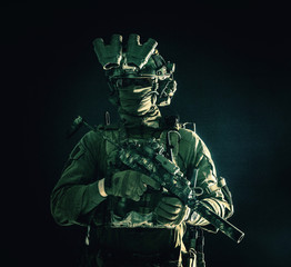 Half length, low key portrait of elite commando fighter, professional mercenary hiding identity...