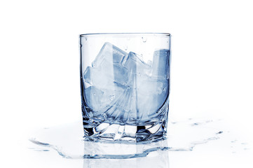 Glass with ice cubes close up isolated on white background