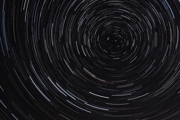 Long exposure starry sky, twisted tracks of stars.
