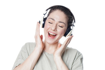 happy young woman with headphones singing along to music with her eyes closed - isolated on white...