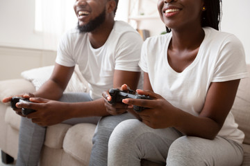 Happy afro guy and girl playing video games with joysticks © Prostock-studio