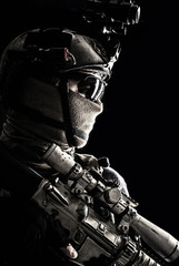 Shoulder portrait of army elite troops sniper, anti-terrorist tactical team marksman wearing helmet with thermal imager, hiding face behind mask, armed rifle with optical scope, studio shoot on black - obrazy, fototapety, plakaty
