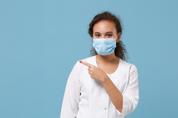 African american doctor woman isolated on blue background. Female doctor in white medical gown...