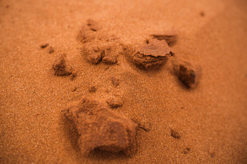 texture of red sand with structures and small stones