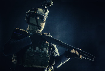 Shoulder portrait of army elite troops soldier, anti-terrorist tactical team wit shotgun, helmet...