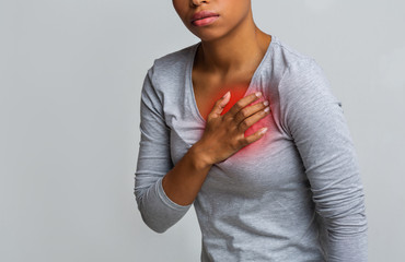 Black young woman suffering from acid reflux or heartburn - obrazy, fototapety, plakaty