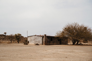 empty house at unpaved road in an African village in the desert