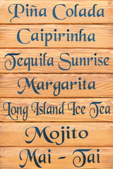 List of available cocktails on the wooden board in Croatian resort bar
