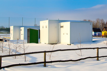 Beautiful houses in the winter recreation Park. Prefabricated houses made of sandwich panels. Frame construction