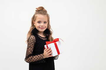 Caucasian girl holds white box with gift and smiles, portrait isolated on white background