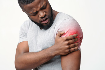 Black man scratching his red itching hand