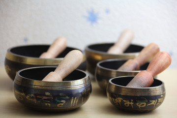 Tibetan Singing bowls with the wooden bats. Chinese symbols translation: jewel in the lotus.