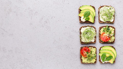 Assortment of vegan toasts with avocado, tofu and microgreens
