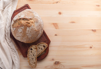 Hot bread on a table made of wood.