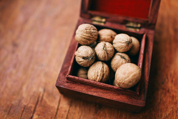 walnuts in a beautiful wooden box on a dark background healthy nuts