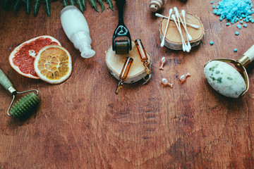 Dermaroller and serum next to an anti aging face cream Beauty industry Close-up Dermaroller for medical micro needling therapy Derma roller mesoroller for mesotherapy. 