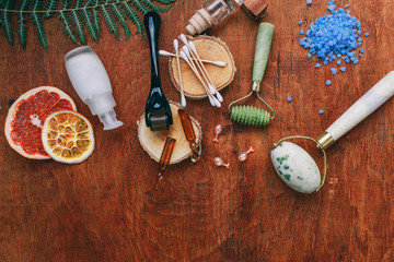 Dermaroller and serum next to an anti aging face cream Beauty industry Close-up Dermaroller for medical micro needling therapy Derma roller mesoroller for mesotherapy. Dermaroller Natural stone