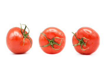 ripe fresh organic tomatoes in drops of water Isolated on a white background