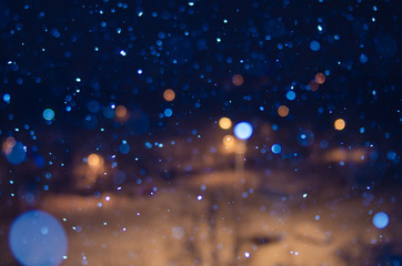 Naklejka na ściany i meble falling snow at night with bokeh effect