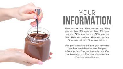 A jar of chocolate spread, spoon in hand on white background isolation, space for text