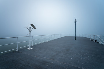 Wooden jetty by the sea on a foggy morning. Baltic Sea Gdynia, Poland