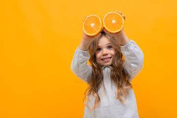 Pretty caucasian girl with hat holds gesticulates with banana isolated on yellow background