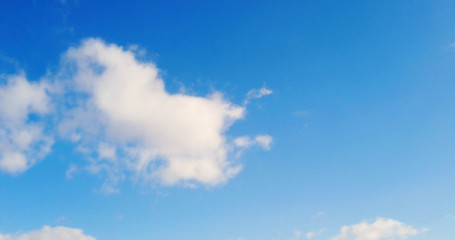Naklejka na ściany i meble White clouds with blue sky background.