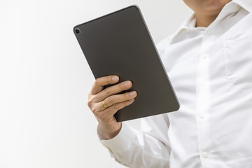 Asian businessman wearing white shirt holding a computer tablet on white background with copy space.