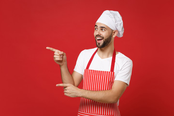 Excited young bearded male chef cook baker man in striped apron white t-shirt toque chefs hat...