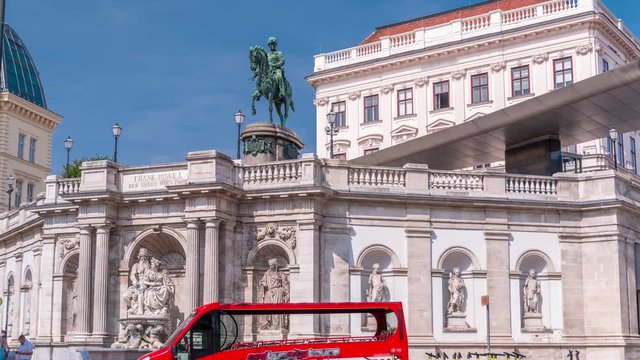 Day view of equestrian statue of Archduke Albert in front of the Albertina Museum timelapse in Vienna, Austria. Historic buildings on a background with blue sky
