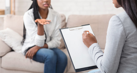 Psychologist having therapy session with her patient in office