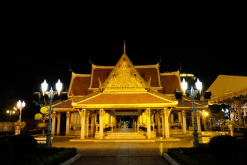 Beautifully decorated passage to the temple complex at night. Night illumination of buildings.