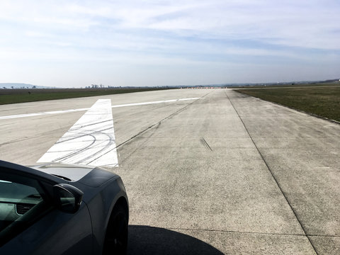 A picture of a car standing on the airport runway before test of acceleration. You can see the GPS antenna on the roof.