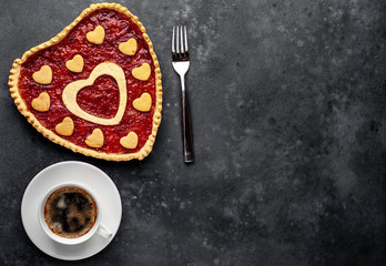 coffee, heart-shaped cake, a gift with a red ribbon for Valentine's Day on  stone background, with copy space for your text. breakfast concept on  saint's day  Valentine.