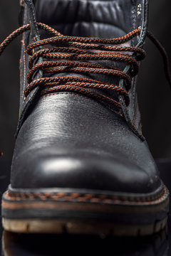 Fragment of black leather men's shoes. Photographed close-up.